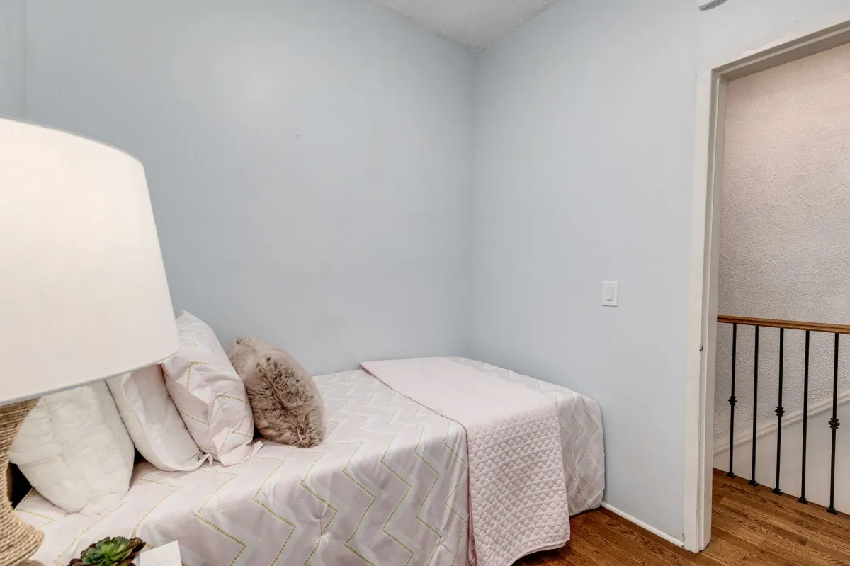Second bedroom with vintage hardwood floor at 56 Hickson St.