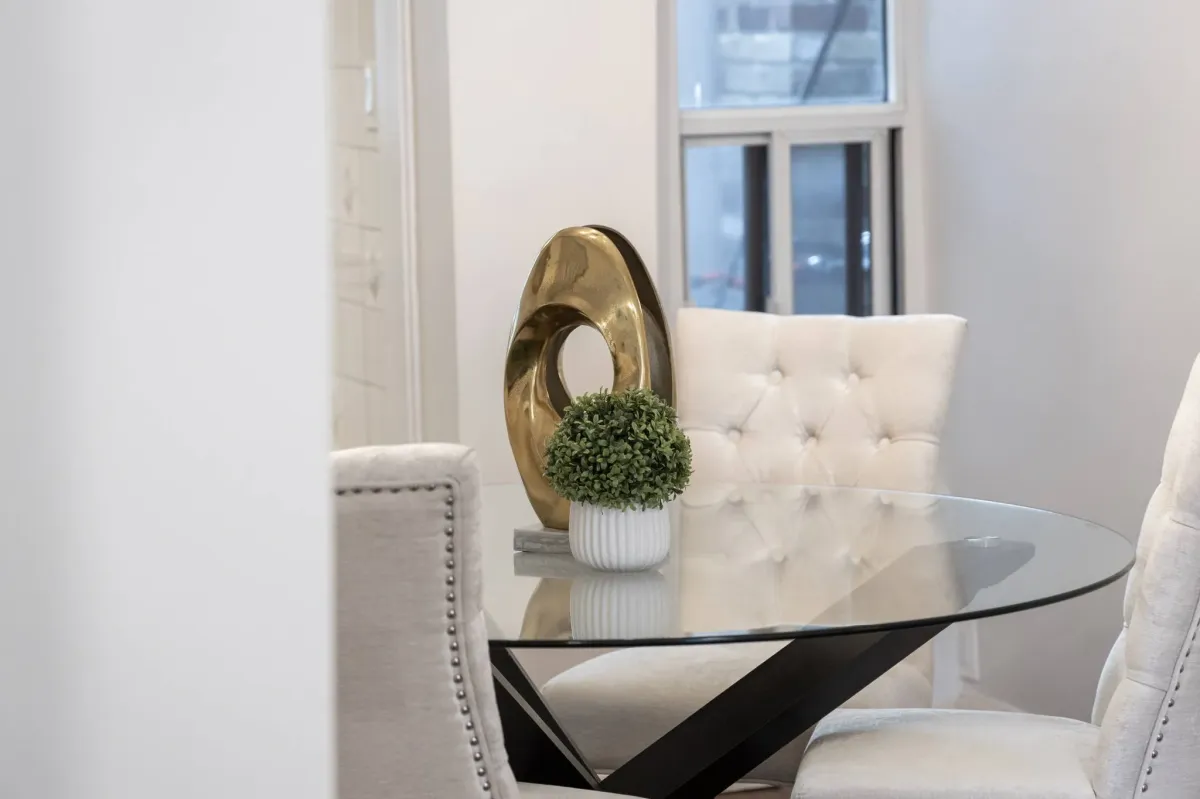Elegant glass dining table with decor at 56 Hickson St.
