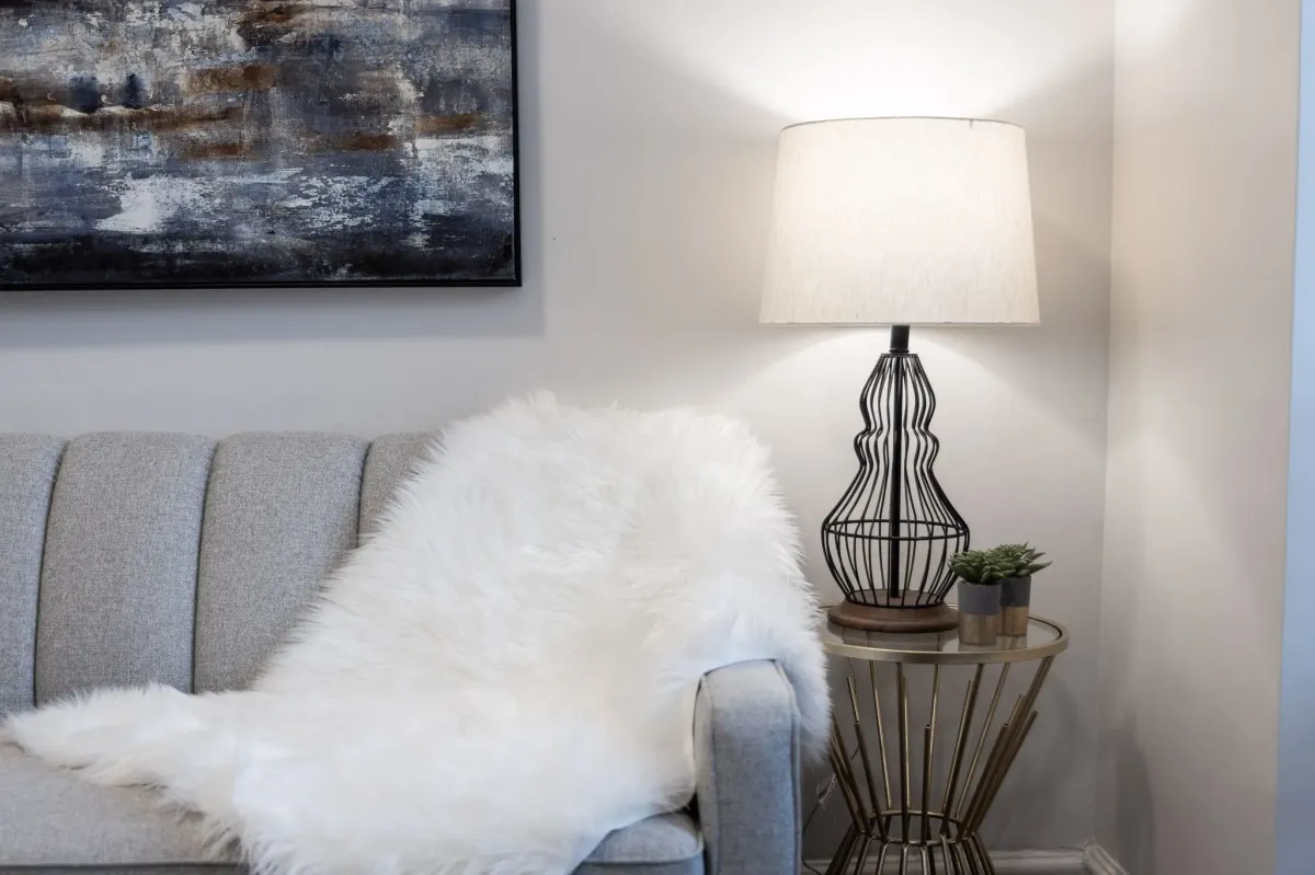 Elegant couch with side table and lamp