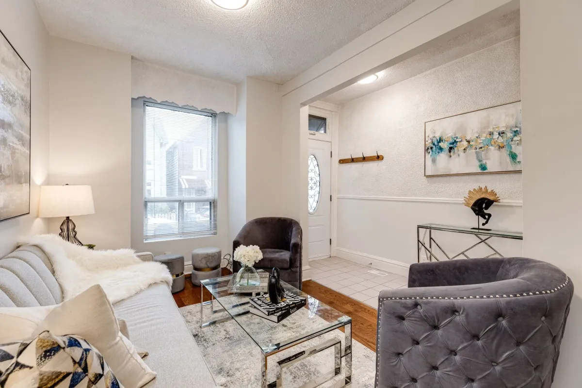 living room and entrance view with couch and 2 arm chairs at townhouse in Little Portugal, Toronto