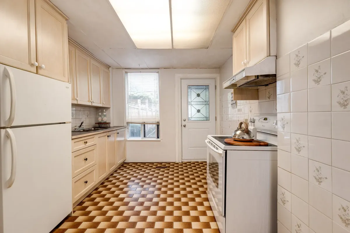 Airy kitchen with back door into fenced backyard at 56 Hickson St.