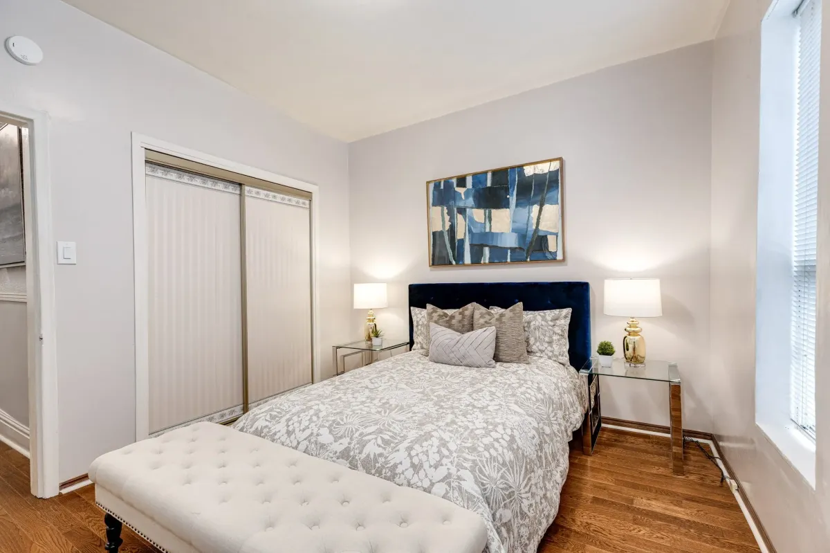 Primary bedroom with window and closet at 56 Hickson St with original hardwood floor