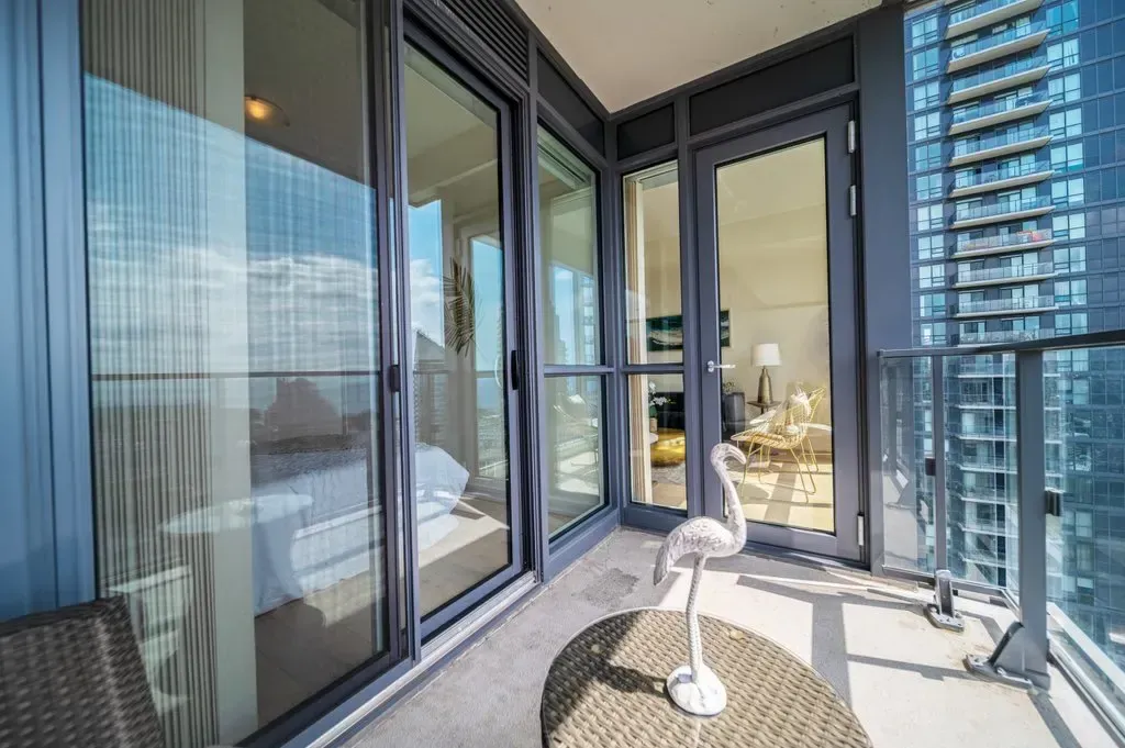 Floor-to-ceiling sliding glass doors leading from the suite at 10 Park Lawn Rd, Unit 3402 to the private balcony.