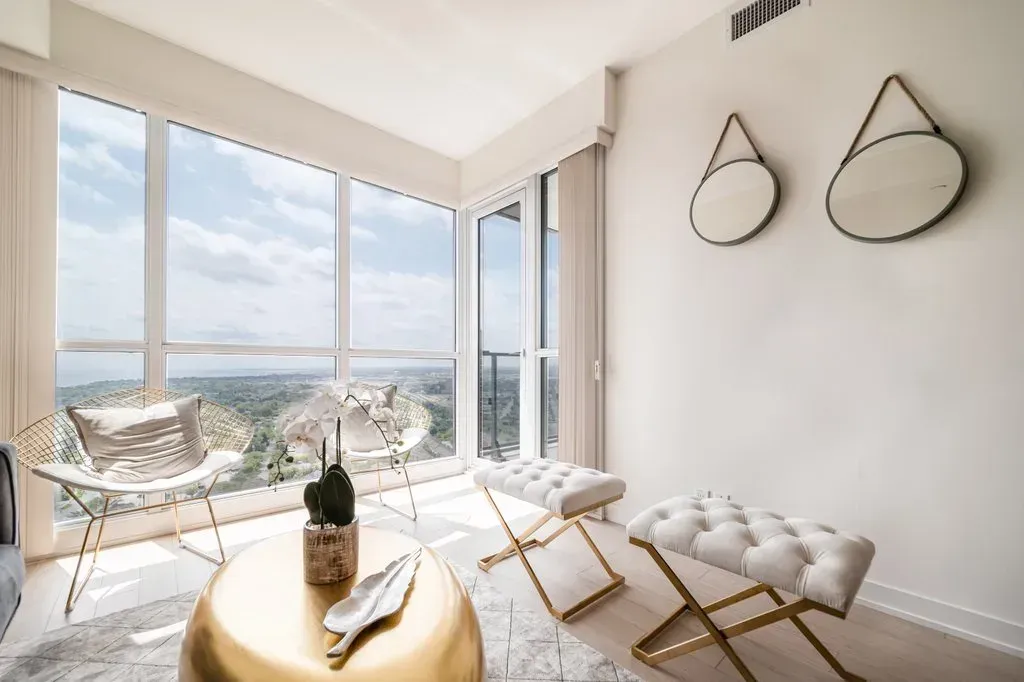 Open-concept living area at 10 Park Lawn Rd, Unit 3402 with gold accents and floor-to-ceiling windows.