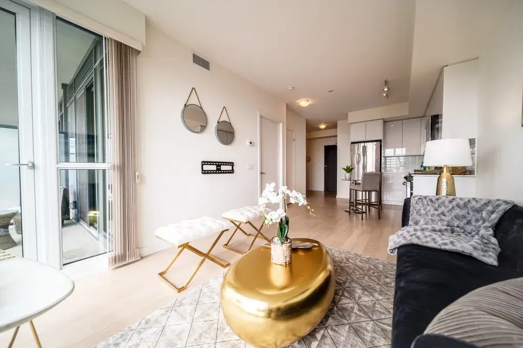 Modern furnishings and light wood flooring throughout the 1-bedroom plus den suite at 10 Park Lawn Rd, Unit 3402.