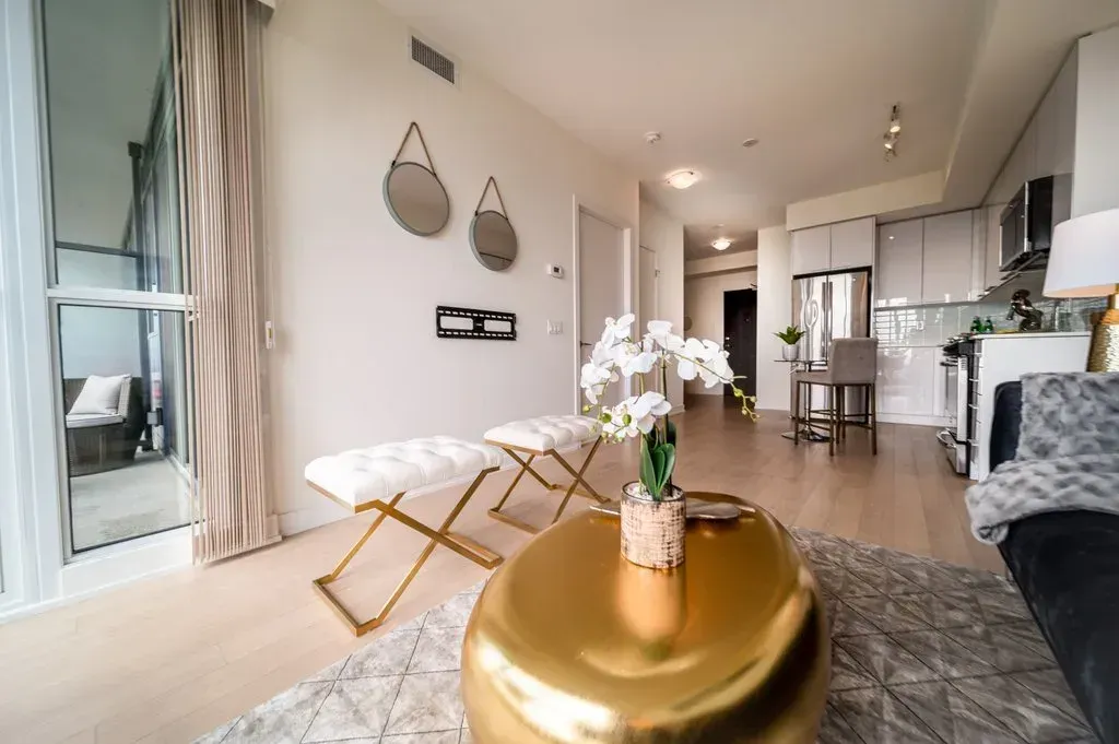 View of the transition between the sun-drenched living space and modern kitchen in 10 Park Lawn Rd, Unit 3402.