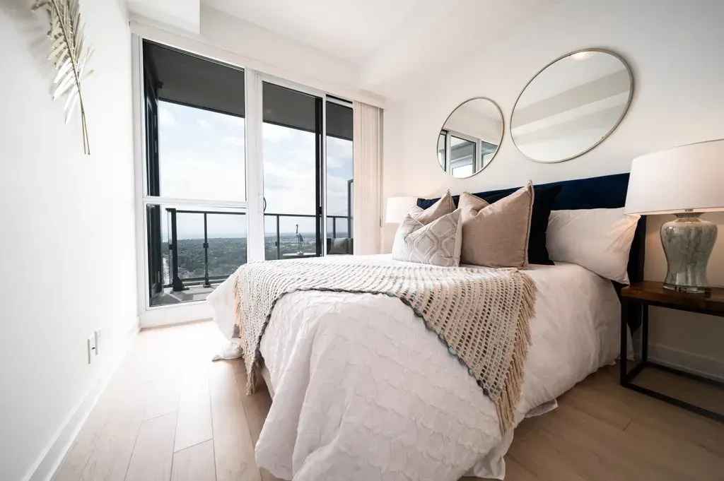 Bright bedroom at 10 Park Lawn Rd, Unit 3402 offering a high-rise view of the Humber Bay Shores community.