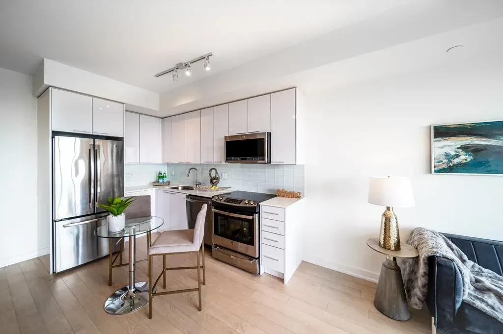 Close-up of the white cabinetry and integrated microwave at 10 Park Lawn Rd, Unit 3402.
