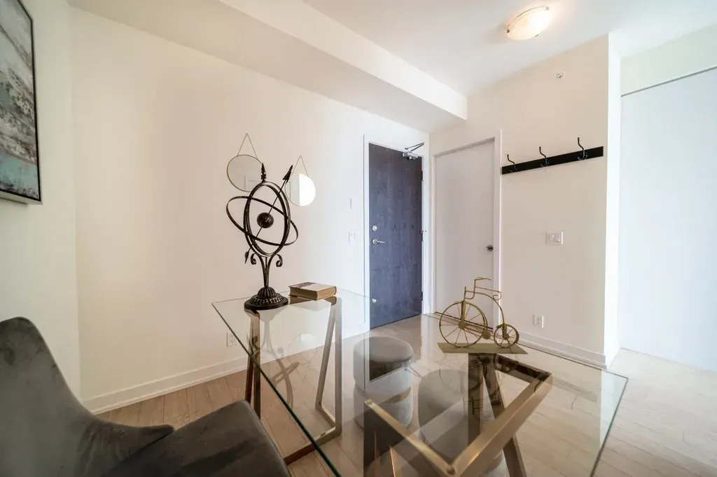 Clean and minimalist foyer of 10 Park Lawn Rd, Unit 3402 with a sleek glass console table.