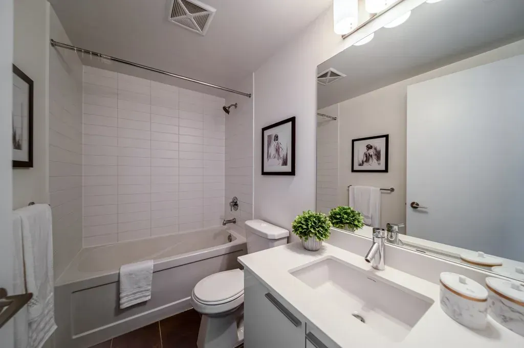 Pristine bathroom at 10 Park Lawn Rd, Unit 3402 with white vanity and soaking tub.