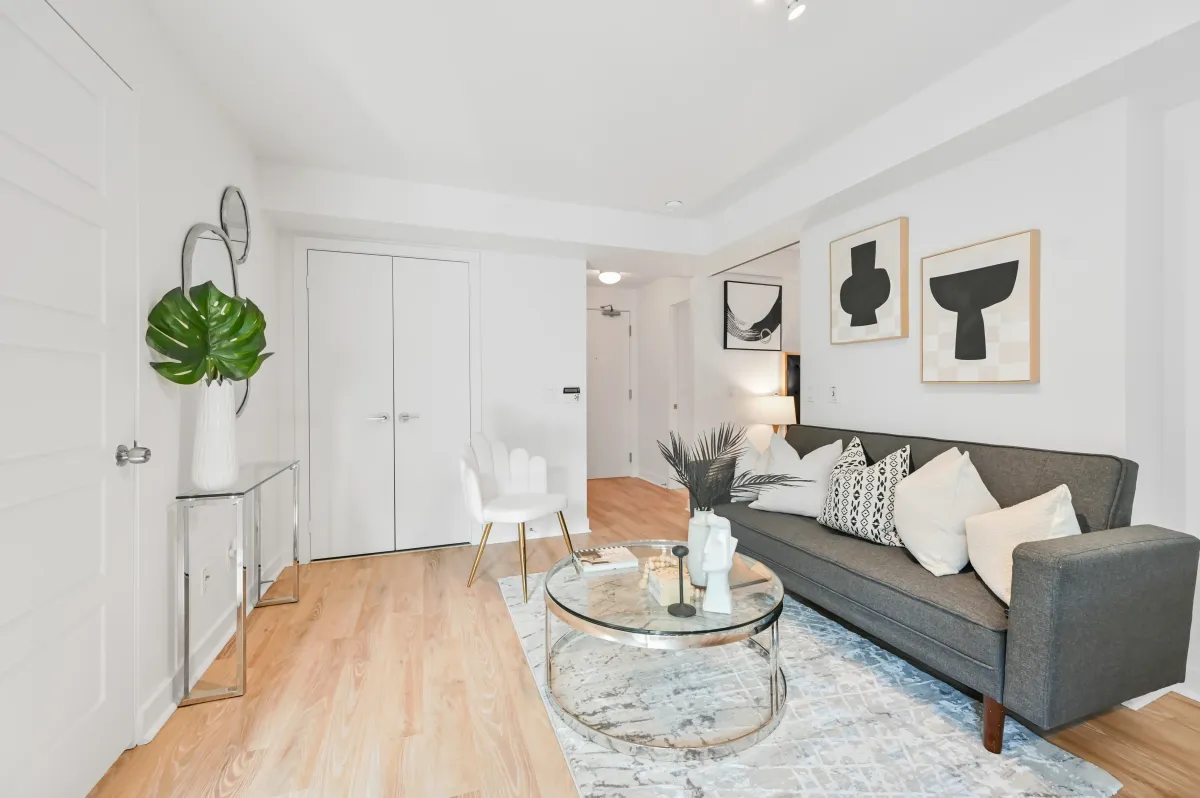 Sun-drenched, open-concept living area at 100 Western Battery Rd, Unit 1911 with contemporary laminate flooring.
