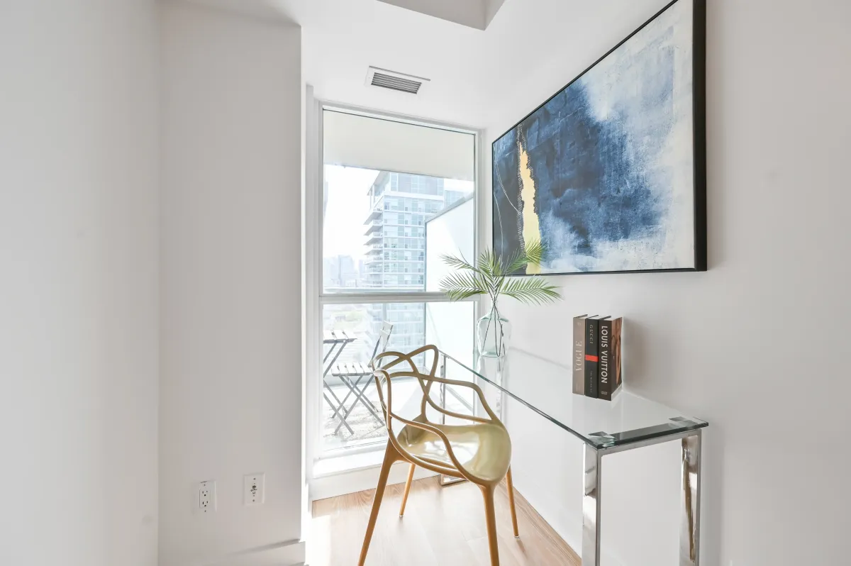 Functional den/office area at 100 Western Battery Rd, Unit 1911 with floor-to-ceiling window views.