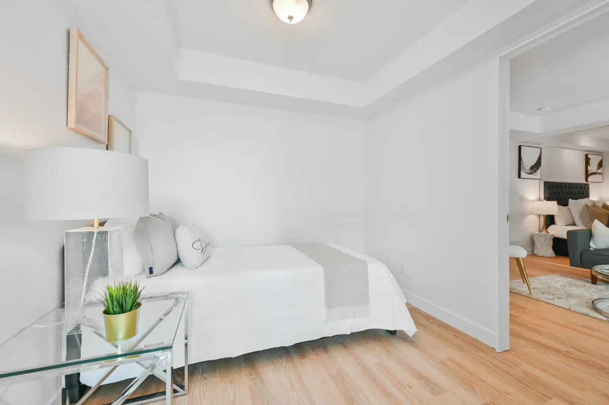 Well-lit second bedroom at 100 Western Battery Rd, Unit 1911, perfect for a guest room or home office.
