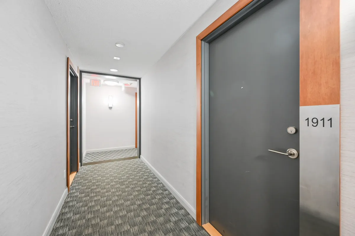 View of the hallway and suite door for 100 Western Battery Rd, Unit 1911.