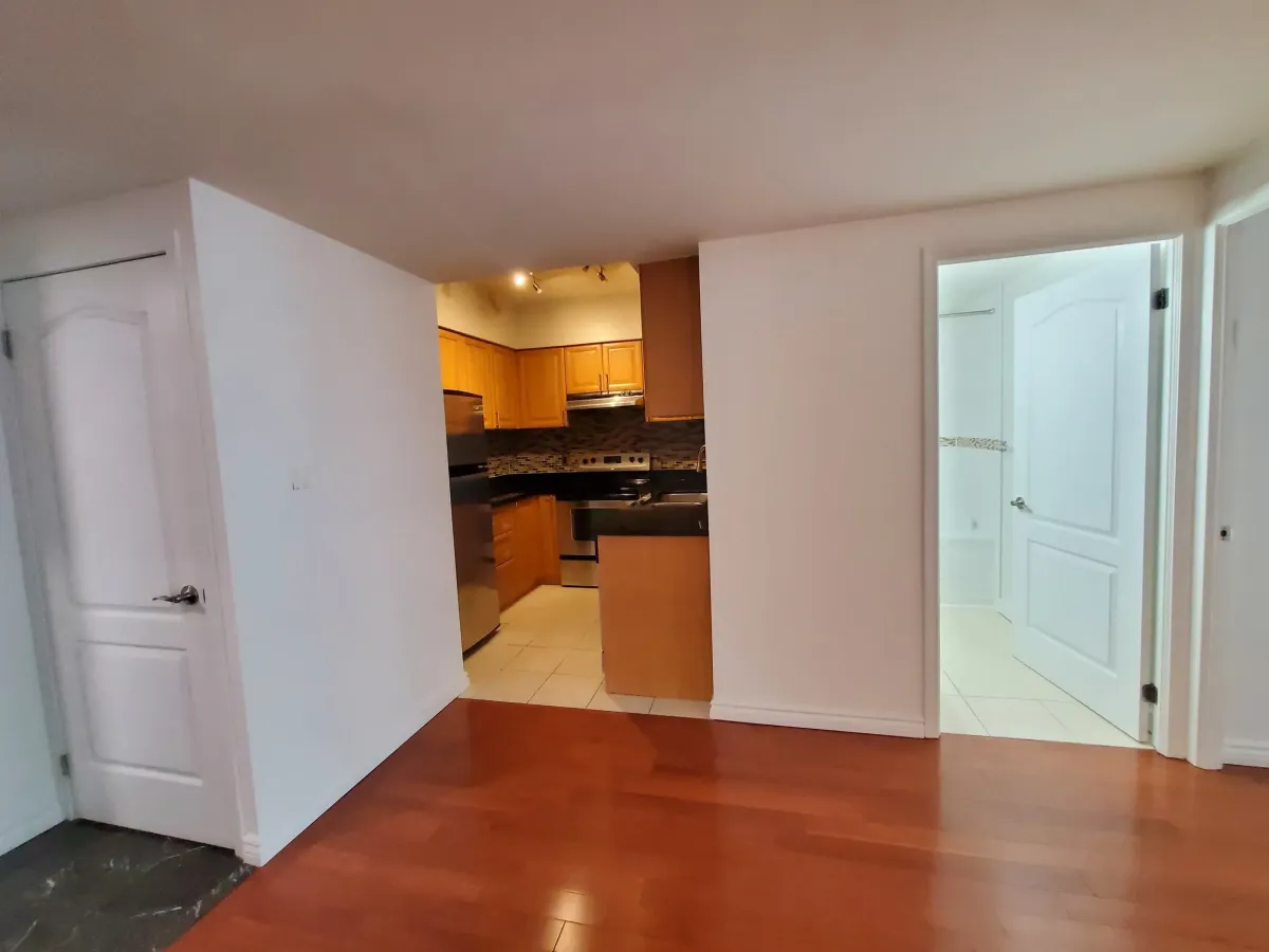 View from the main living area toward the chef's kitchen and foyer at 263 Wellington St W, Unit 701.