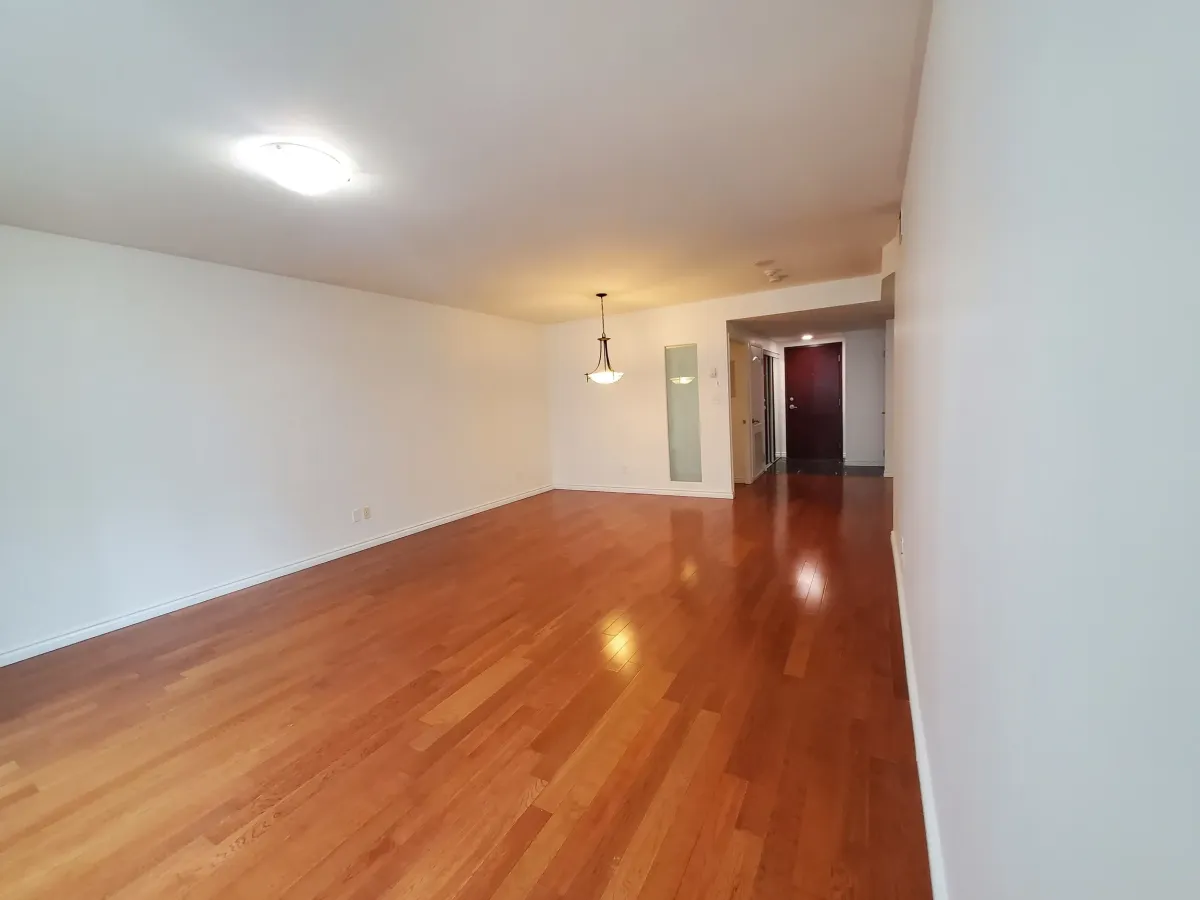 Long view of the sophisticated living and dining space within 263 Wellington St W, Unit 701.