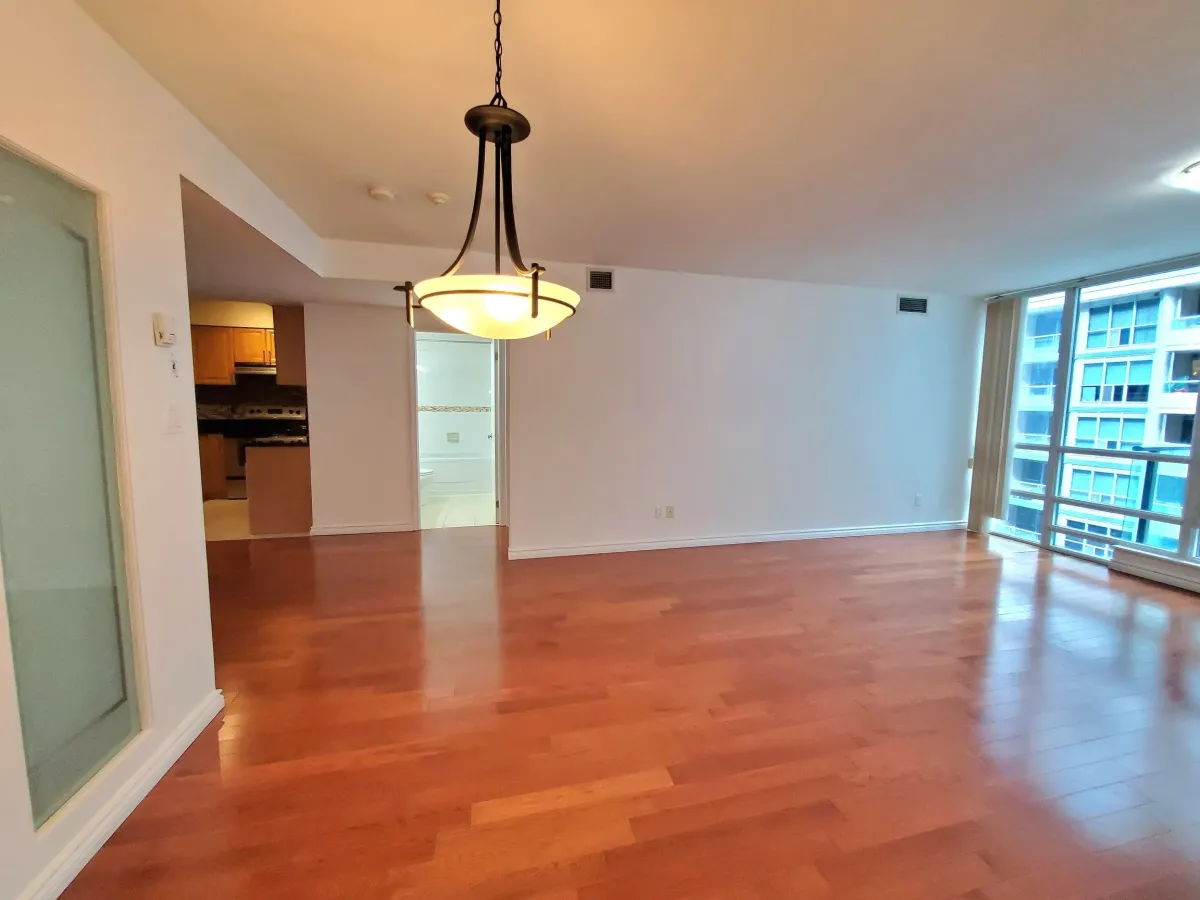 Sun-drenched living space at 263 Wellington St W, Unit 701 highlighting the smooth flat ceilings and airy boutique feel.
