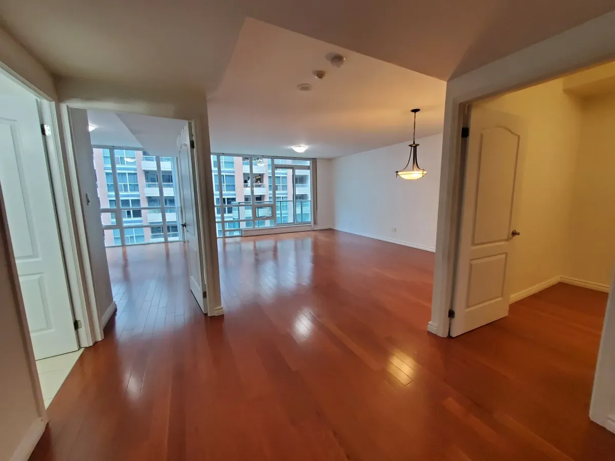 Wide-angle view of the living area at 263 Wellington St W, Unit 701 showing the 100 Walk Score location view.