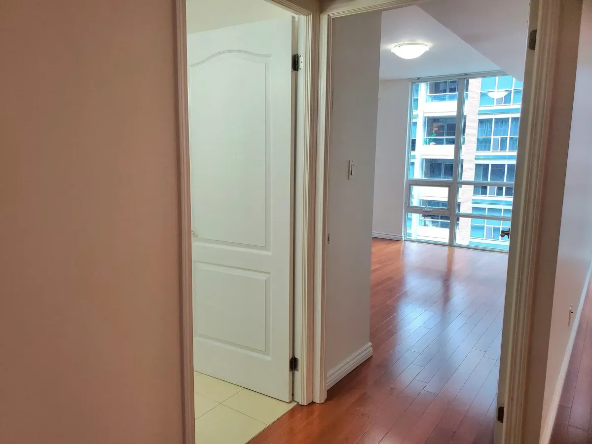 Hallway leading to the tranquil primary bedroom at 263 Wellington St W, Unit 701.