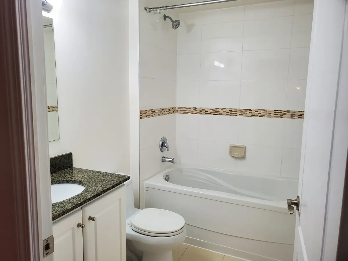 Pristine bathroom at 263 Wellington St W, Unit 701 featuring a soaking tub and contemporary white tiling.