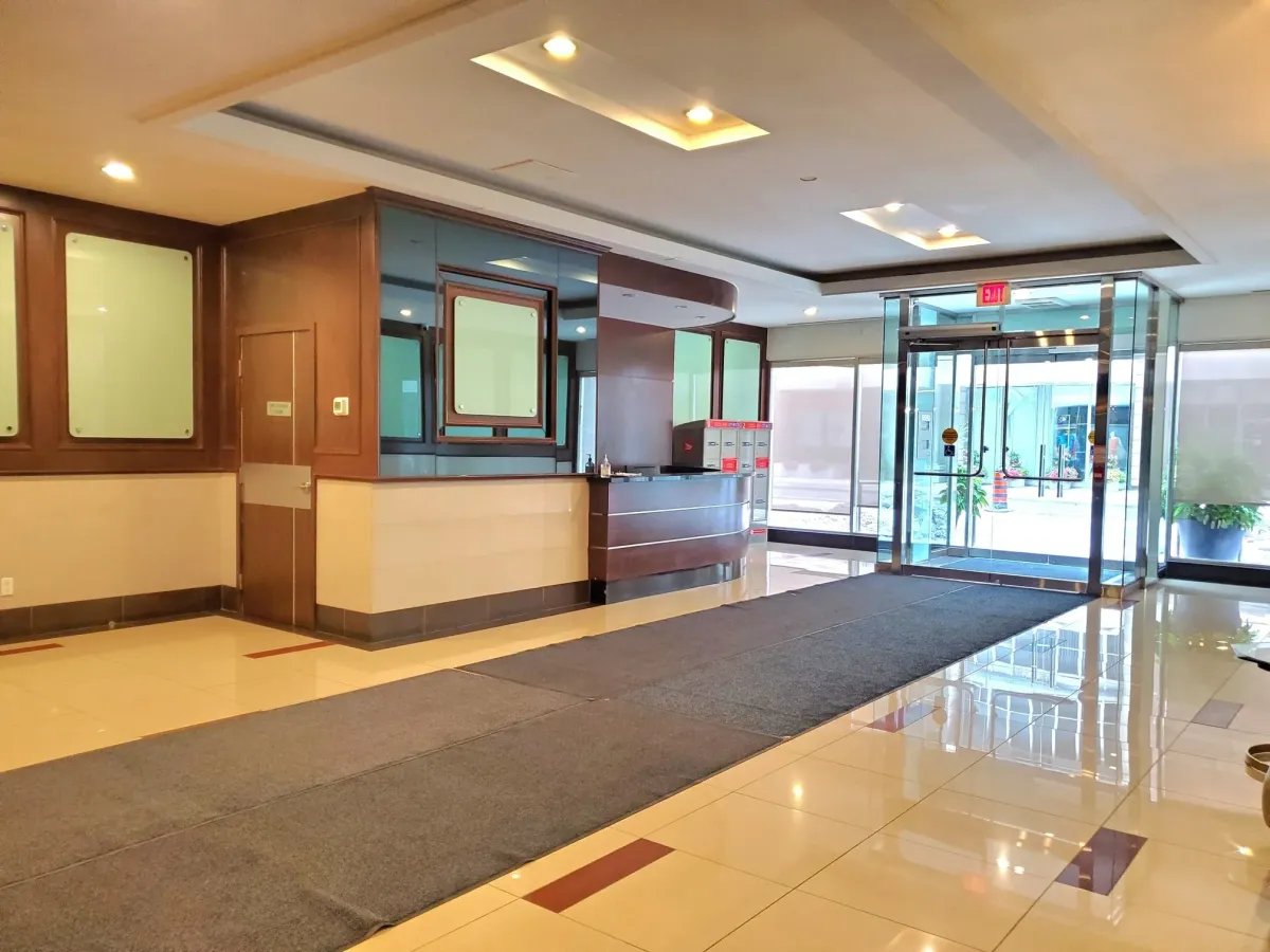 Sophisticated building foyer and concierge station at the prestigious 263 Wellington St W, Unit 701.