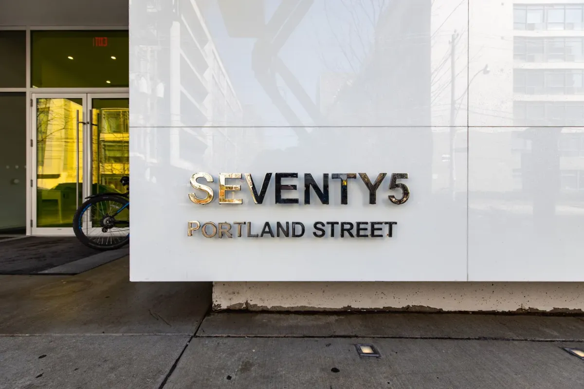 Designer lobby signage for Seventy5 Portland at 75 Portland St #807, featuring the iconic minimalist branding.