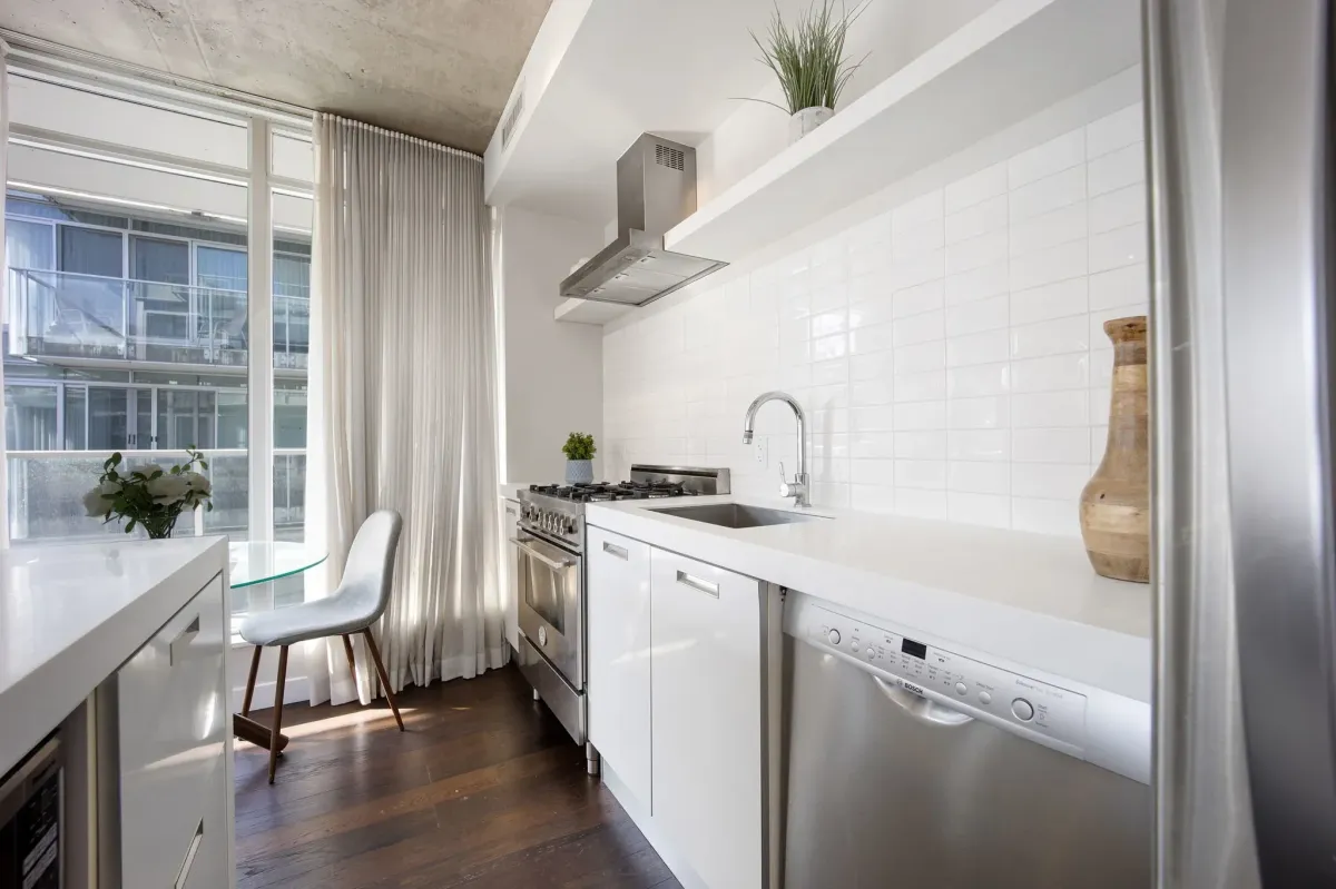 Gourmet kitchen detail at 75 Portland St #807, featuring a premium Bertazzoni gas range and upgraded stainless steel appliances.