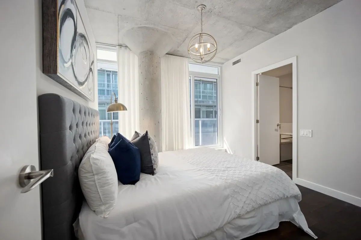 Contemporary bedroom at 75 Portland St #807, showing the clean lines and designer lighting of this Philippe Starck masterpiece.