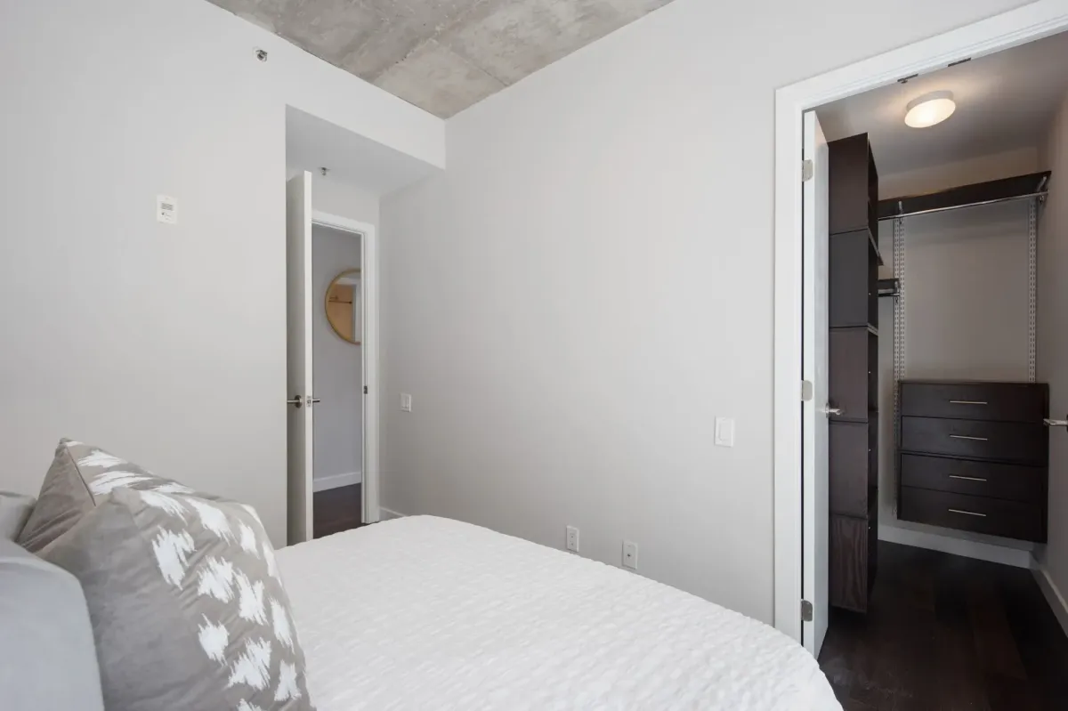 Airy secondary bedroom or home office space at 75 Portland St #807, highlighting the versatile "Live-Work-Play" floor plan.