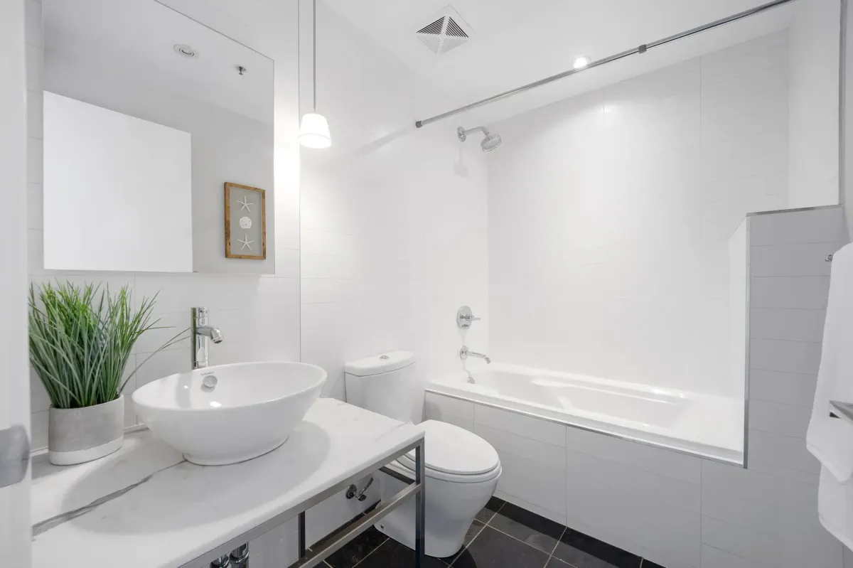 Spa-like 4-piece ensuite bathroom in the primary suite of 75 Portland St #807, with premium tile and deep soaking tub.