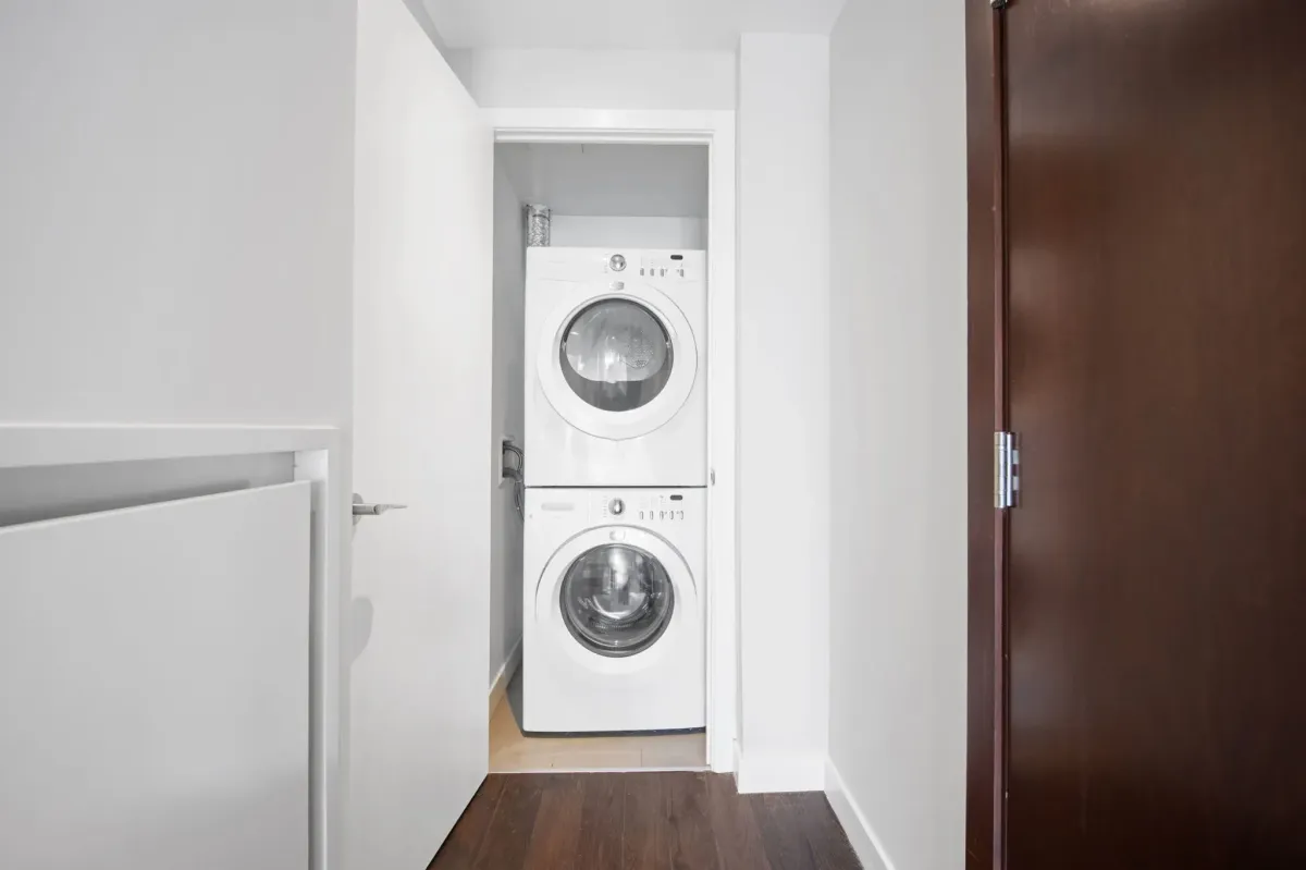 In-suite laundry closet with stacked washer and dryer at 75 Portland St #807 for ultimate urban convenience.