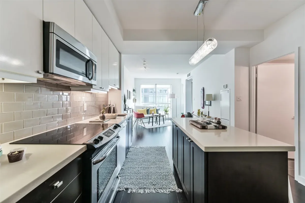 Primary bedroom at 1169 Queen St W, Unit N502, with modern furniture and exposed concrete details.