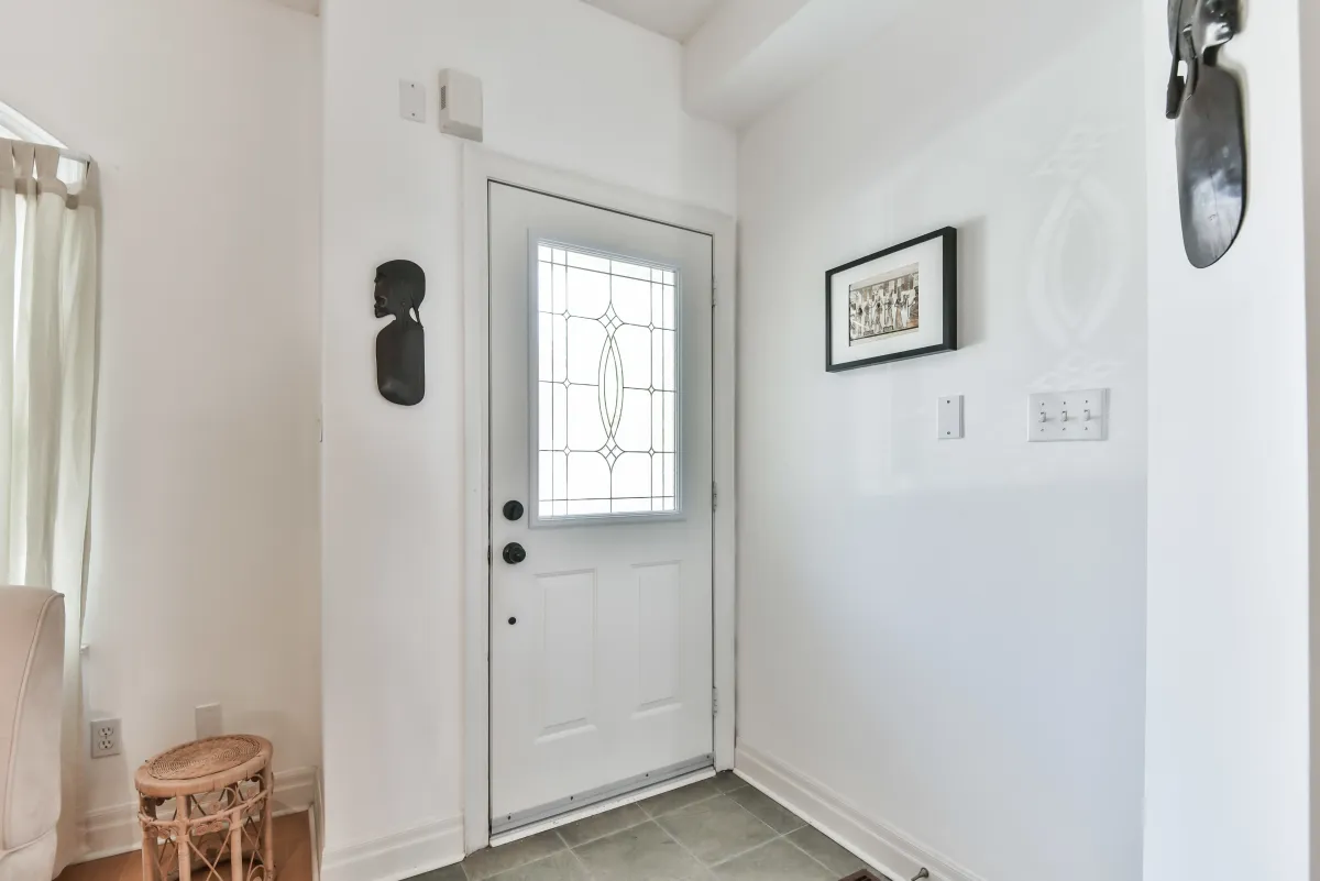 Clean and bright entryway at 9 Algarve Cres, featuring a secure front door and neutral decor.