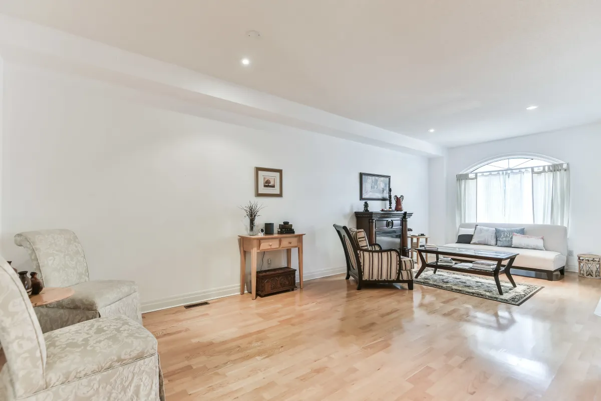 Sun-drenched living room at 9 Algarve Cres, showing the seamless flow between the entry and the family living space.
