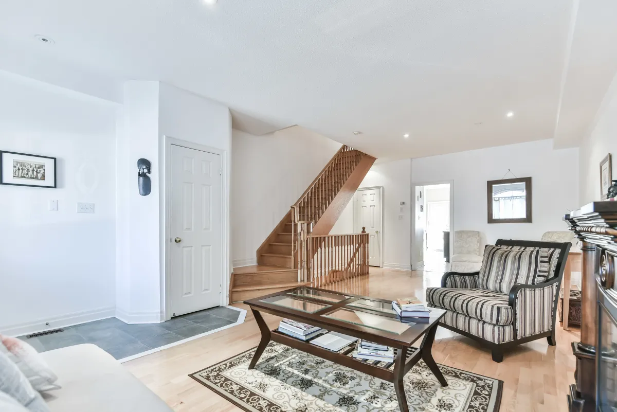 Open-concept main level at 9 Algarve Cres, highlighting the transition from the living area to the upper staircase.