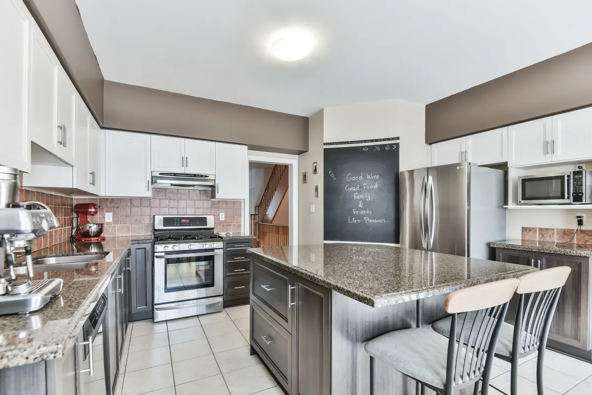 Chef-inspired kitchen at 9 Algarve Cres, featuring premium granite countertops and a functional eat-in island.