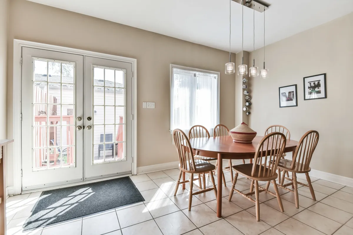 Formal dining area at 9 Algarve Cres with large glass doors leading to the private backyard sanctuary.