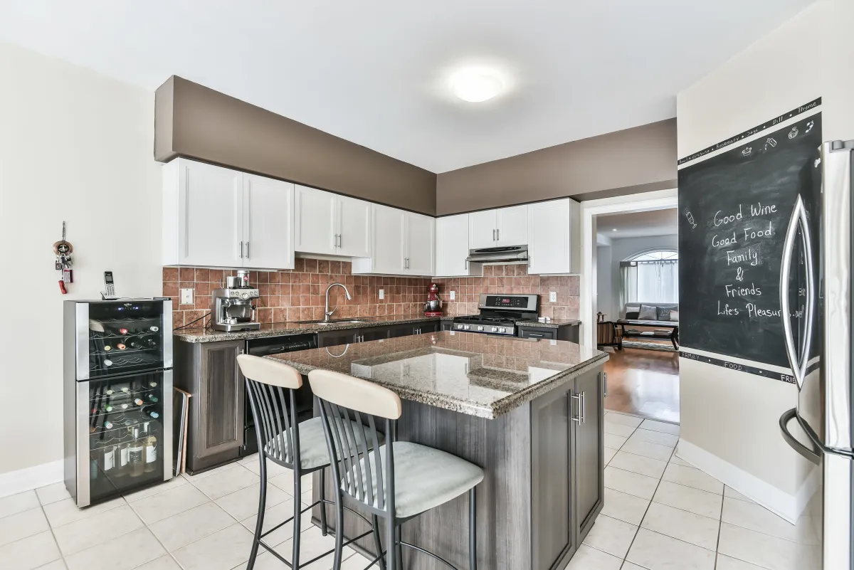 Modern open-concept kitchen and dining room at 9 Algarve Cres, highlighting the professional-grade gas stove.