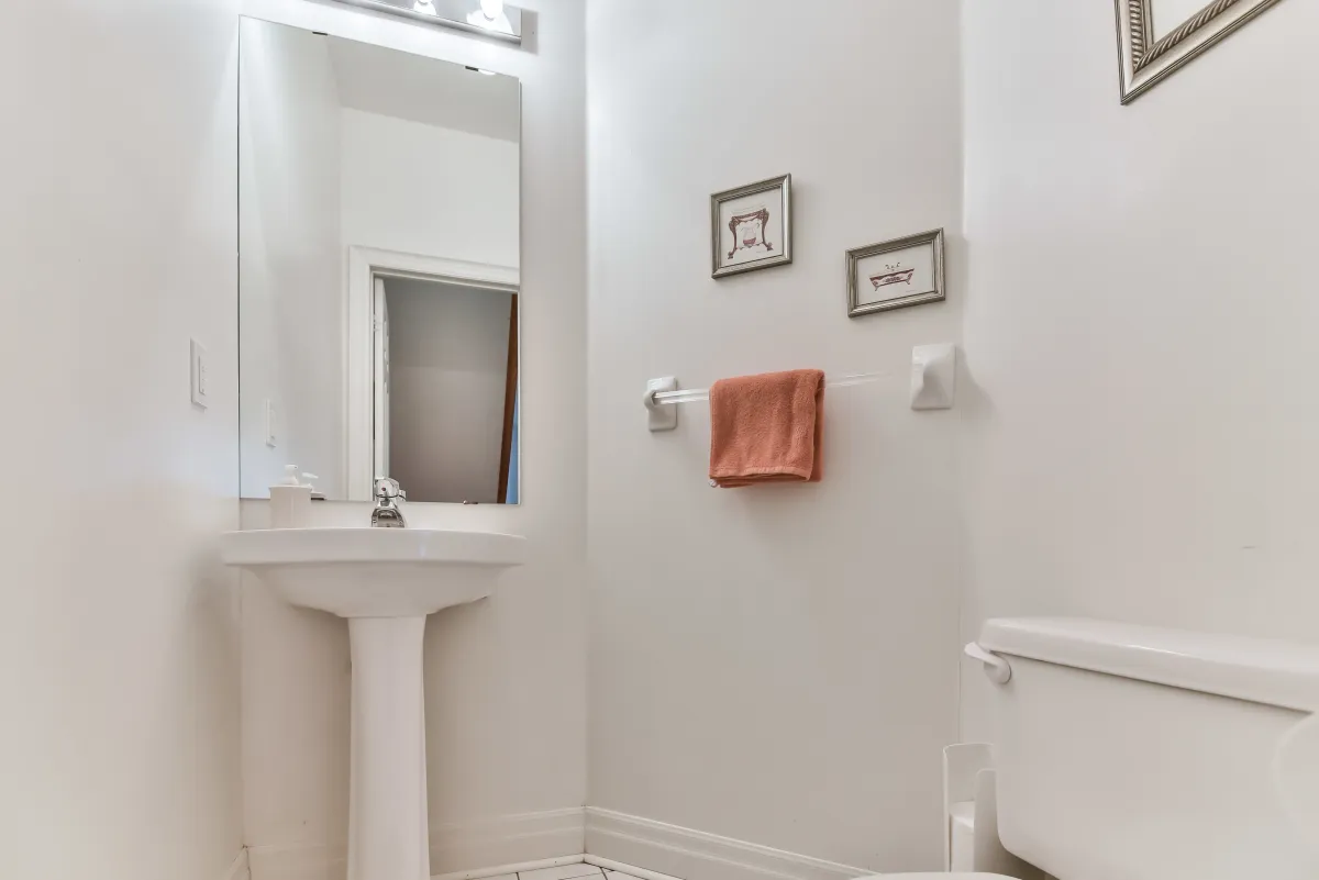 Convenient powder room at 9 Algarve Cres, featuring a pedestal sink and clean, modern finishes.