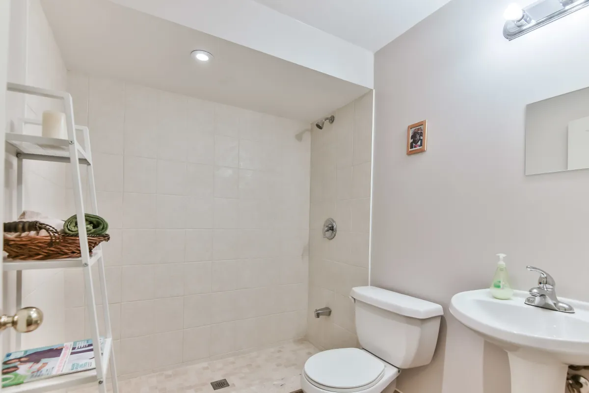 Modern secondary bathroom at 9 Algarve Cres with a glass-enclosed walk-in shower.