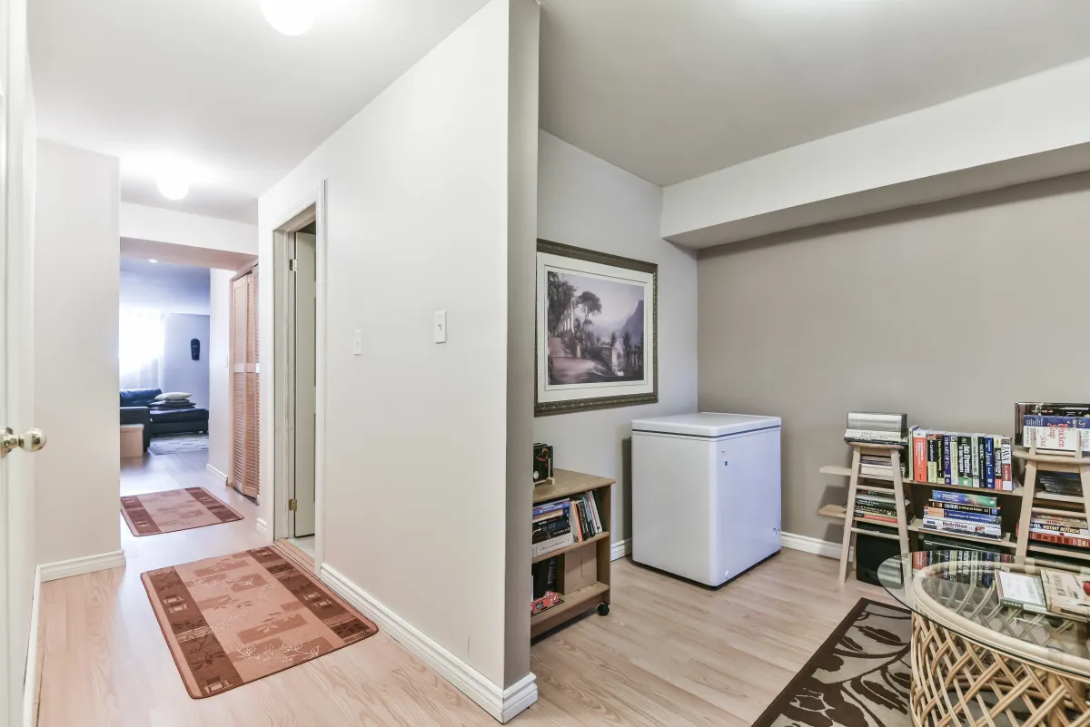 Bright hallway in the lower level of 9 Algarve Cres, leading to the dedicated den and storage.