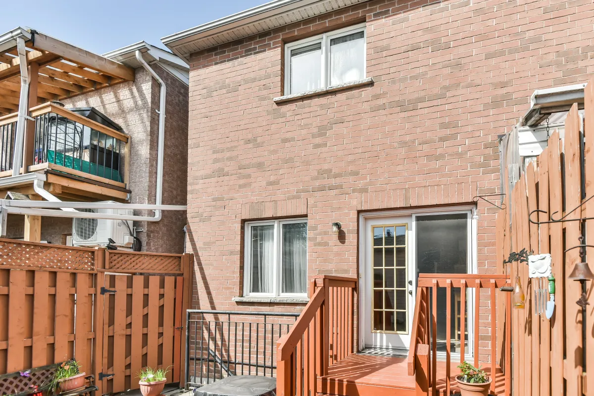 Rear exterior of 9 Algarve Cres, showing the brick construction and walk-out to the wooden deck.