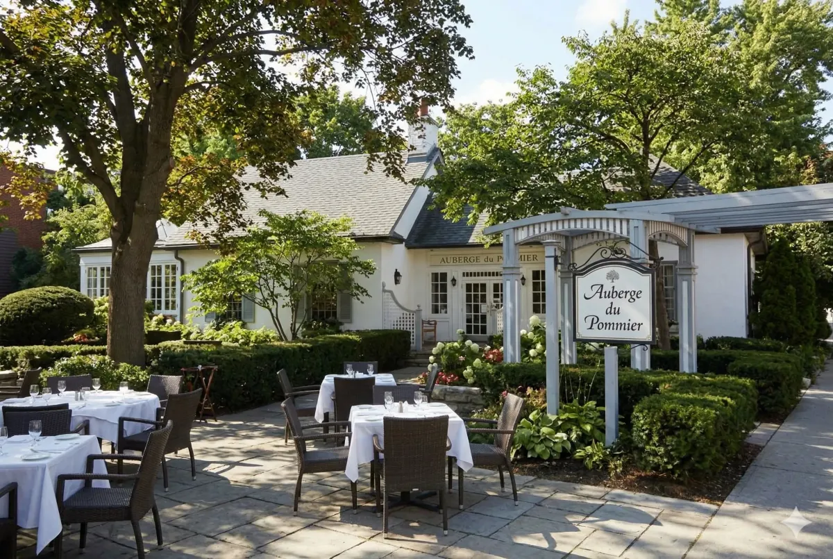 The historic 1860s wood-and-stone cottage exterior of Auberge du Pommier, a French fine-dining landmark in North York, Toronto.
