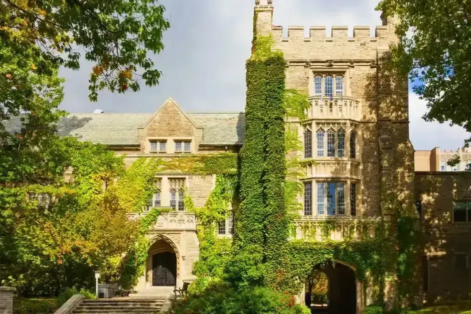 The historic stone architecture of a major educational institution in Hamilton surrounded by greenery.