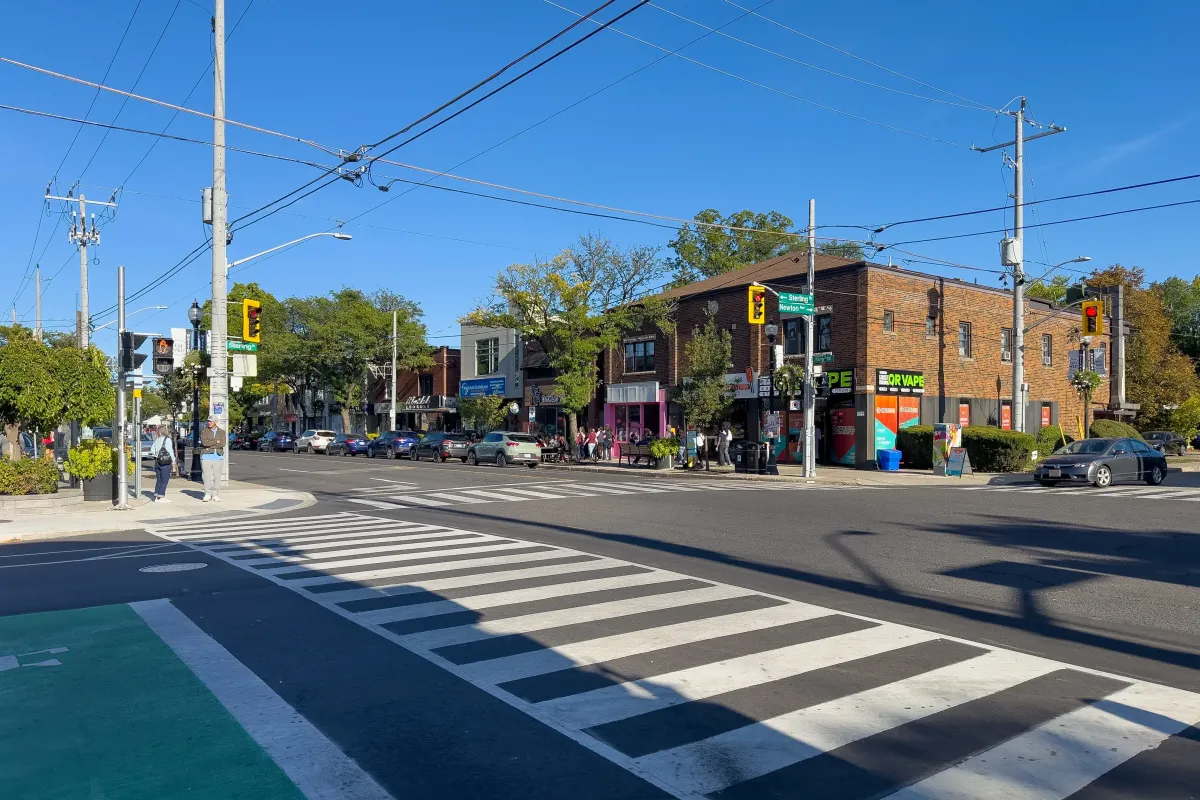 Pedestrian crossing and local storefronts in the Westdale Village shopping district.