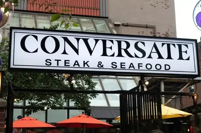 Vibrant storefront and patio of The Coop Wicked Chicken restaurant.