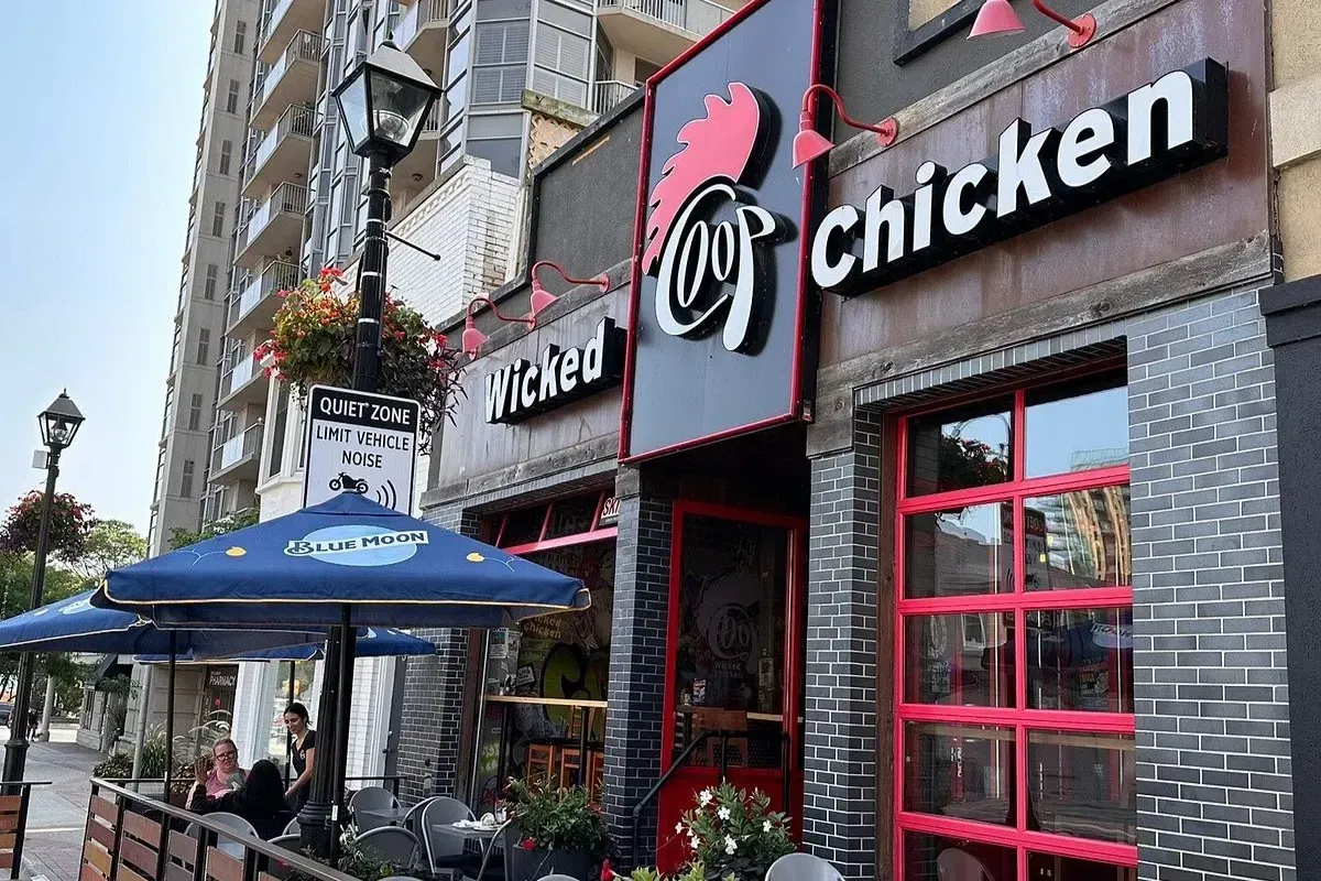 The historic hanging sign for Coach and Lantern British Pub in Ancaster.