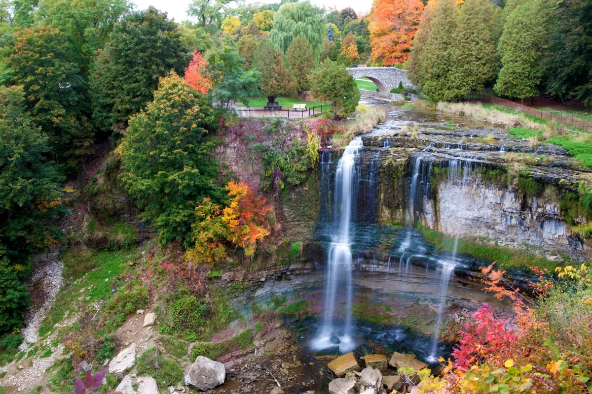 A scenic view of Webster's Falls in Hamilton surrounded by colorful fall foliage.