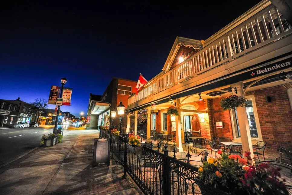 Nighttime view of the historic illuminated storefronts in Streetsville, Mississauga.