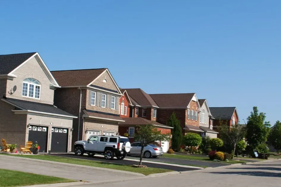A quiet residential street with two-story detached homes in the Lisgar community.